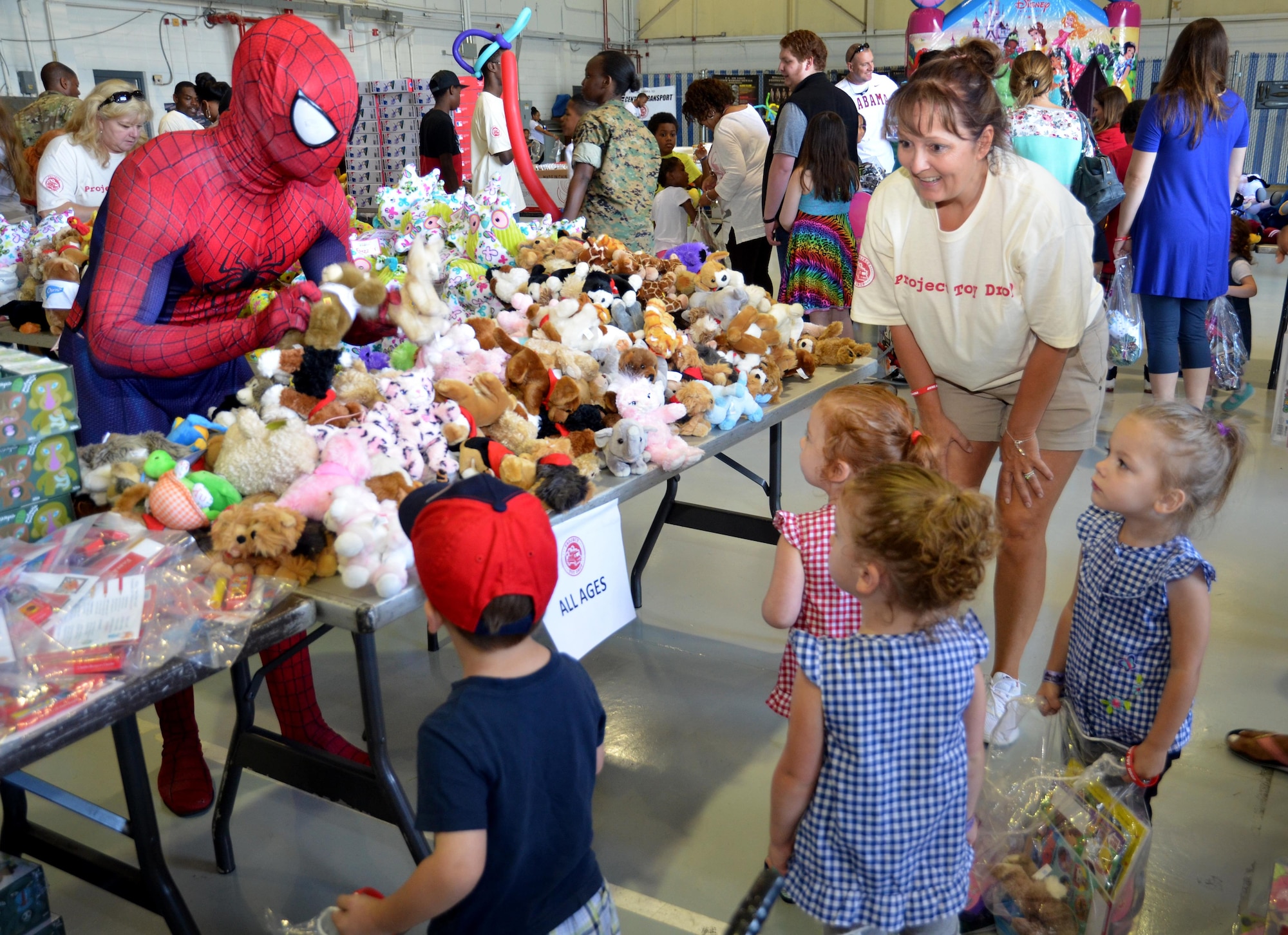 Spiderman hands out toys to children attending the Military Kids Appreciation Day at Dobbins Air Reserve Base, Ga. July 9, 2017. In addition to distributing nearly $30,000 worth of toys, the event also hosted various characters from popular movies. (U.S. Air Force photo by Senior Airman Lauren Douglas)