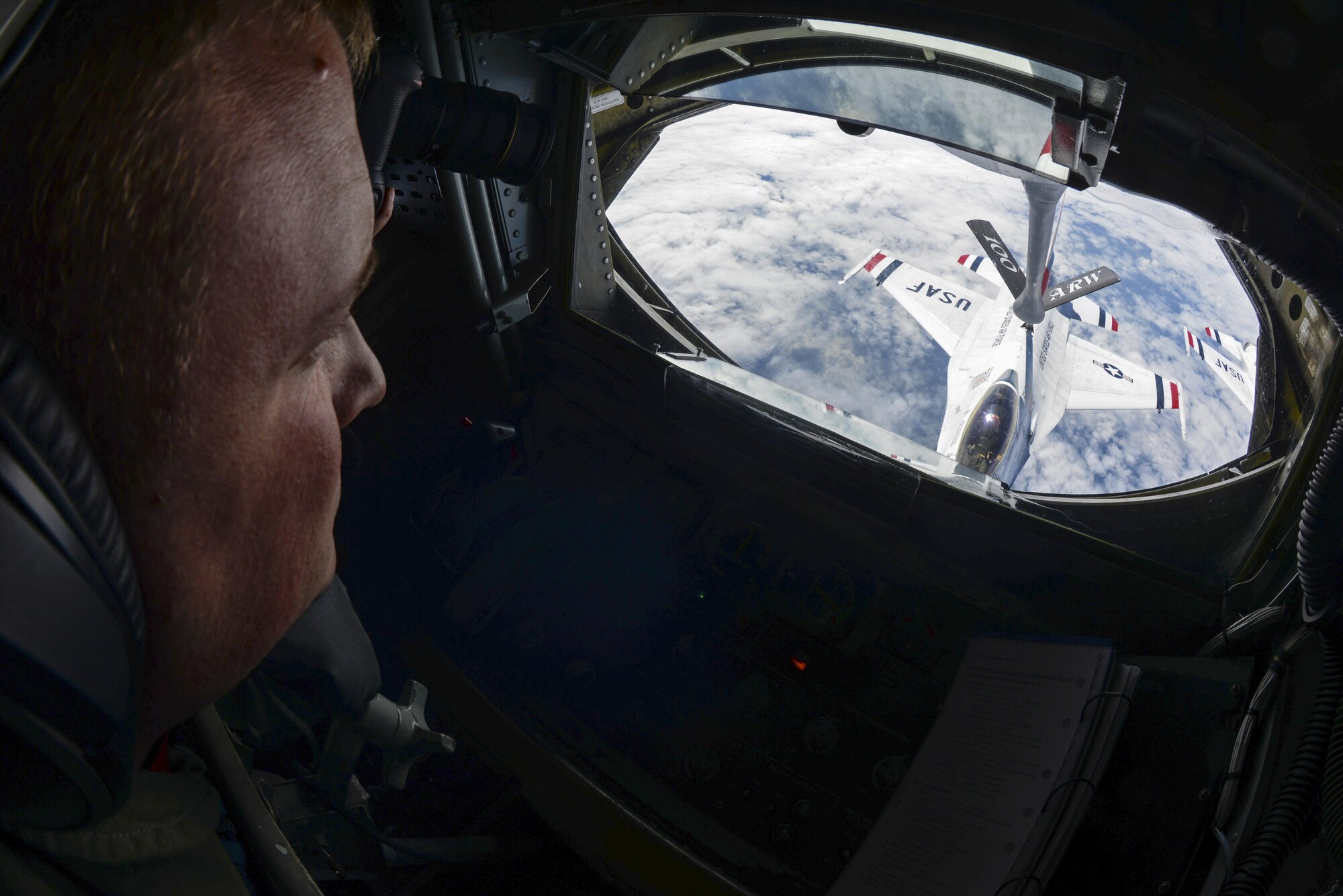 U.S. Air Force Senior Airman Joseph Wukasch, 351st Air Refueling Squadron boom operator, operates the boom July 14, 2017, to provide air refueling for a U.S. Air Force Thunderbird over France. The Thunderbirds were on their way to the 2017 Royal International Air Tattoo airshow at RAF Fairford, England, after performing flyovers at Bastille Day in Paris. (U.S. Air Force photo by Senior Airman Justine Rho)