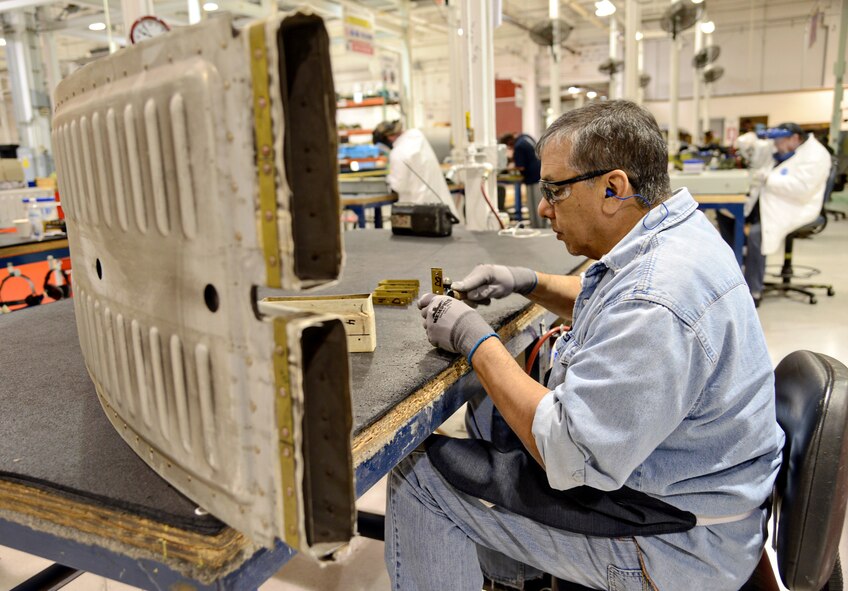 Kenneth Forehand, a sheet metal mechanic makes a repair on a riser duct, which allows airflow to the KC-135 aircraft. (Air Force photo by Kelly White)