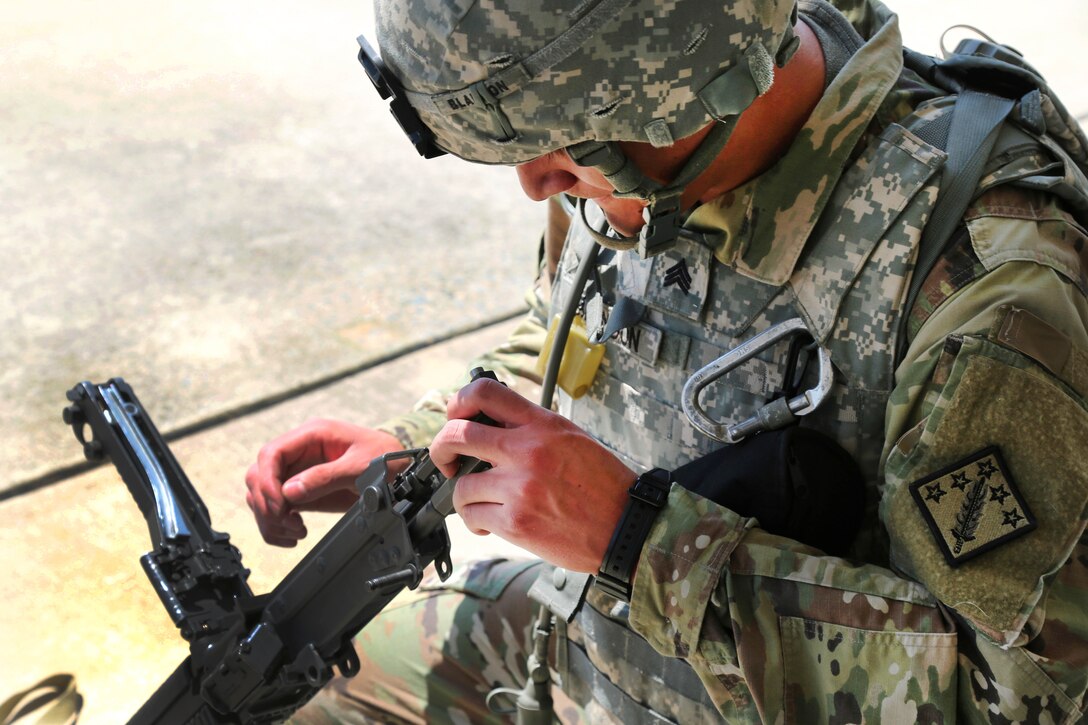Army Sgt. Kenneth Blandon assembles a M249 light machine gun during a weapons knowledge test during the Best Warrior Competition at Aberdeen Proving Ground, Md., July 10, 2017. Blandon is assigned to the 20th Chemical, Biological, Radiological, Nuclear and Explosives Command. Army photo by Sgt. Kalie Jones