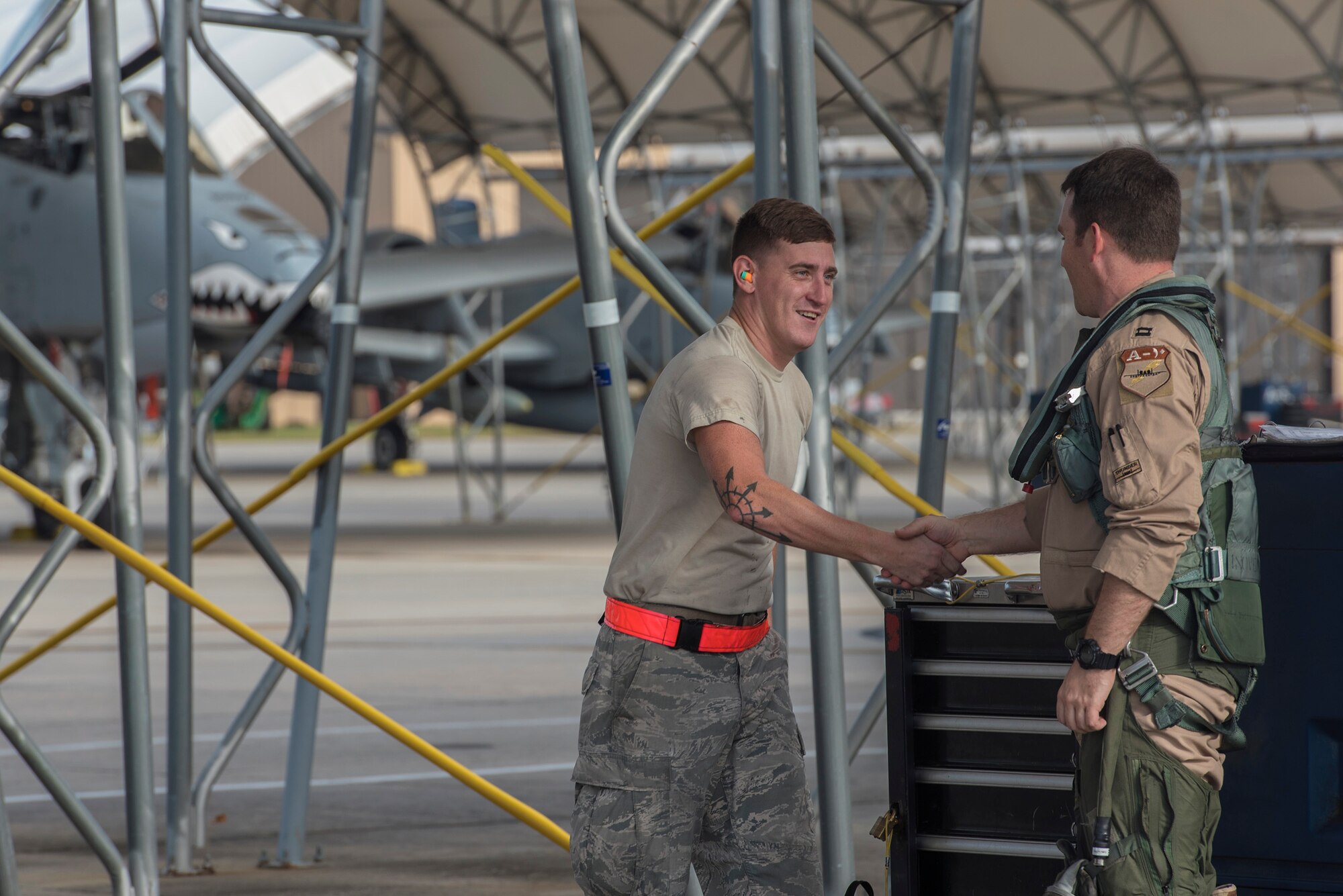 Senior Airman Cody Pennington, 476th Maintenance Squadron crew chief, left, greets Capt. Thomas Ainscough, 74th Fighter Squadron A-10C Thunderbolt II pilot, prior to deploying, July 11, 2017, at Moody Air Force Base, Ga. More than 300 Airmen deployed to Southwest Asia to aid the 74th Fighter Squadron’s A-10 mission in support of Operation Inherent Resolve. (U.S. Air Force photo by Senior Airman Greg Nash)