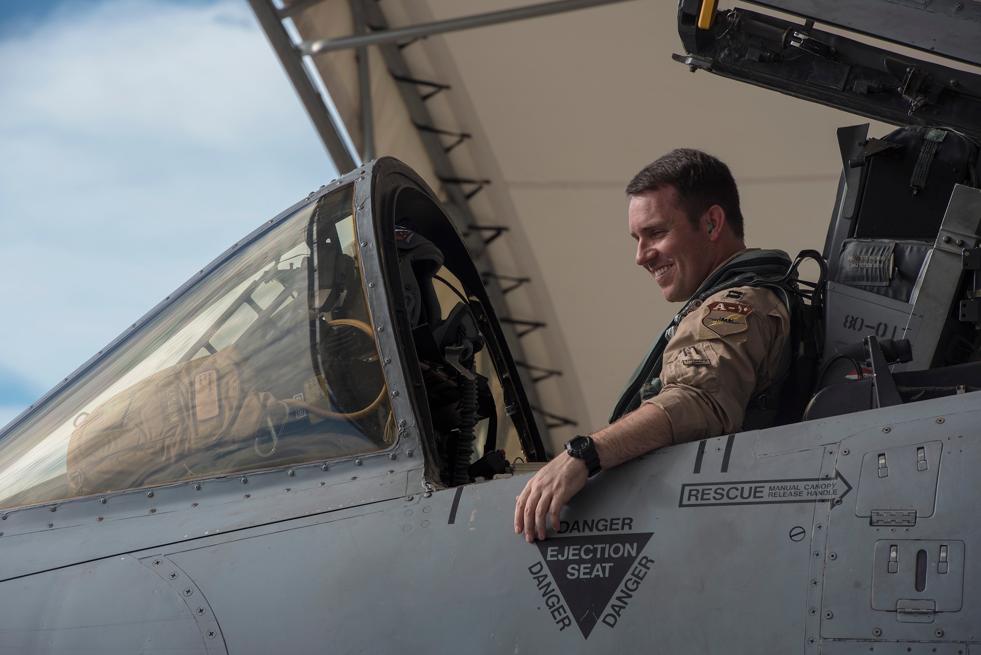 Capt. Thomas Ainscough, 74th Fighter Squadron A-10C Thunderbolt II pilot, smiles during a pre-flight inspection prior to deploying, July 11, 2017, at Moody Air Force Base, Ga. More than 300 Airmen deployed to Southwest Asia to aid the 74th Fighter Squadron’s A-10 mission in support of Operation Inherent Resolve. (U.S. Air Force photo by Senior Airman Greg Nash)