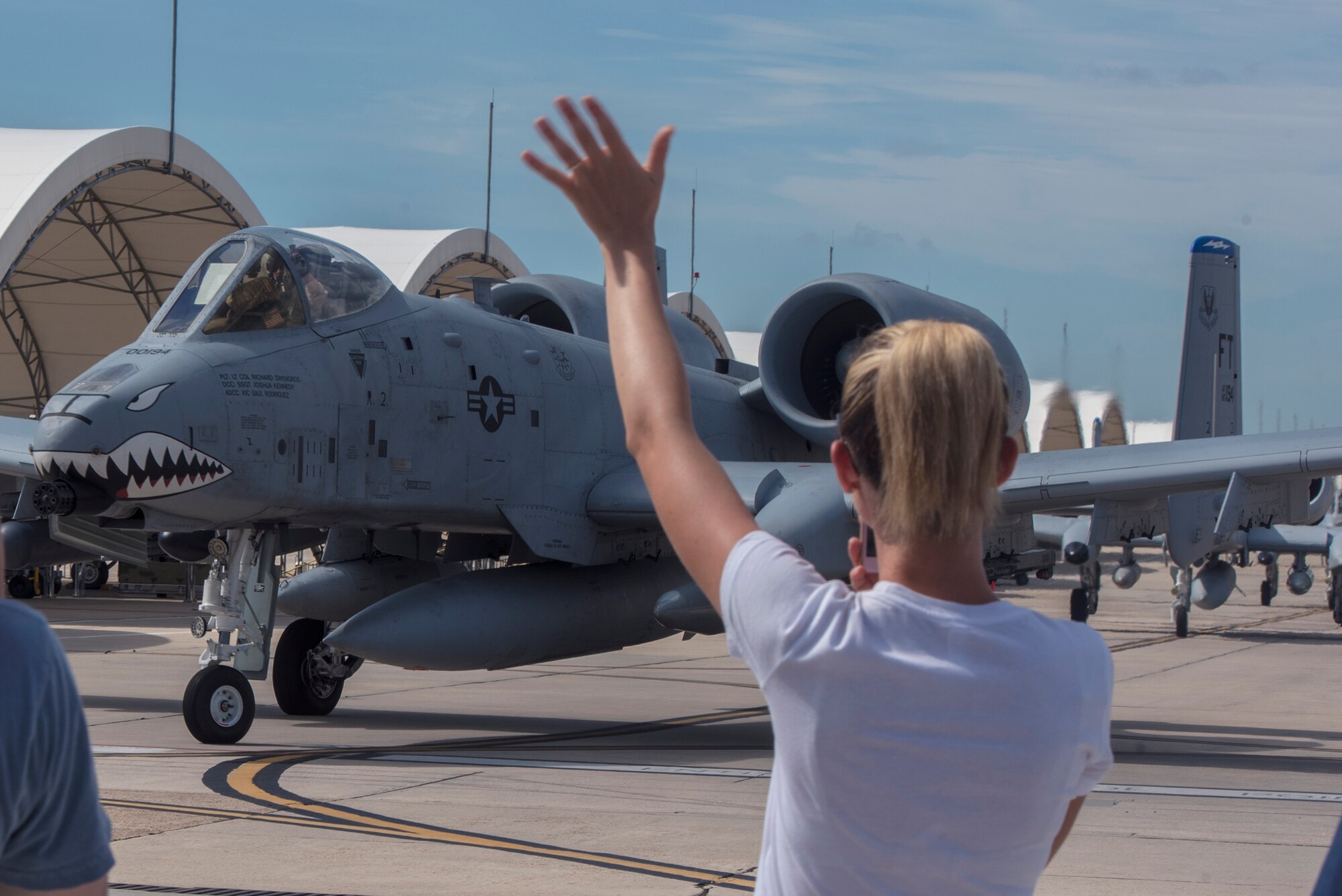 A spectator waves goodbye to a 74th Fighter Squadron A-10C Thunderbolt II pilot as he departs for a deployment, July 11, 2017, at Moody Air Force Base, Ga. More than 300 Airmen deployed to Southwest Asia to aid the 74th Fighter Squadron’s A-10 mission in support of Operation Inherent Resolve. (U.S. Air Force photo by Senior Airman Greg Nash)