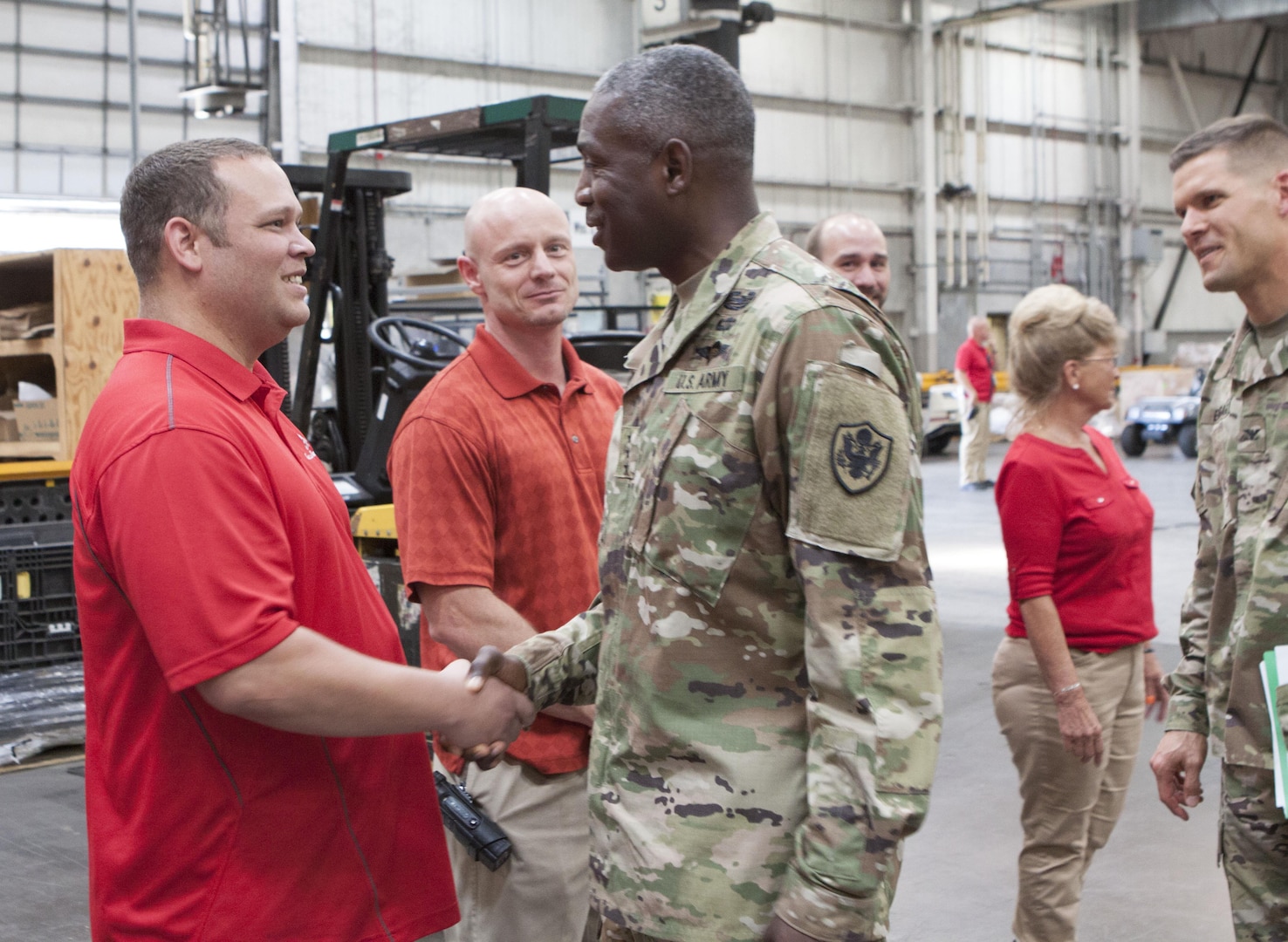 Army Col. Brad Eungard (far right), commander of DLA Distribution Susquehanna, leads DLA Director Army Lt. Gen. Darrell K. Williams (center) on a tour through the facility. Williams met the Susquehanna workforce and talked with them as they described their roles in the agency.