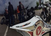 Participants in a motorcycle safety course huddle together to discuss what they have learned in a previous exercise July 14, 2017, here. Many of the participants were veteran riders who desired refresher training. (U.S. Air Force Photo/Senior Airman Jeffrey Grossi)
