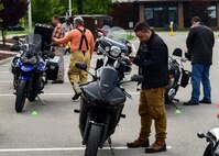 Senior Airman Brandon Simmons, an administration journeyman with 910th Maintenance Group, checks his smartphone while on break during a motorcycle safety course July 14, 2017, here. Simmons has been riding motorcycles for more than five years. (U.S. Air Force Photo/Senior Airman Jeffrey Grossi)