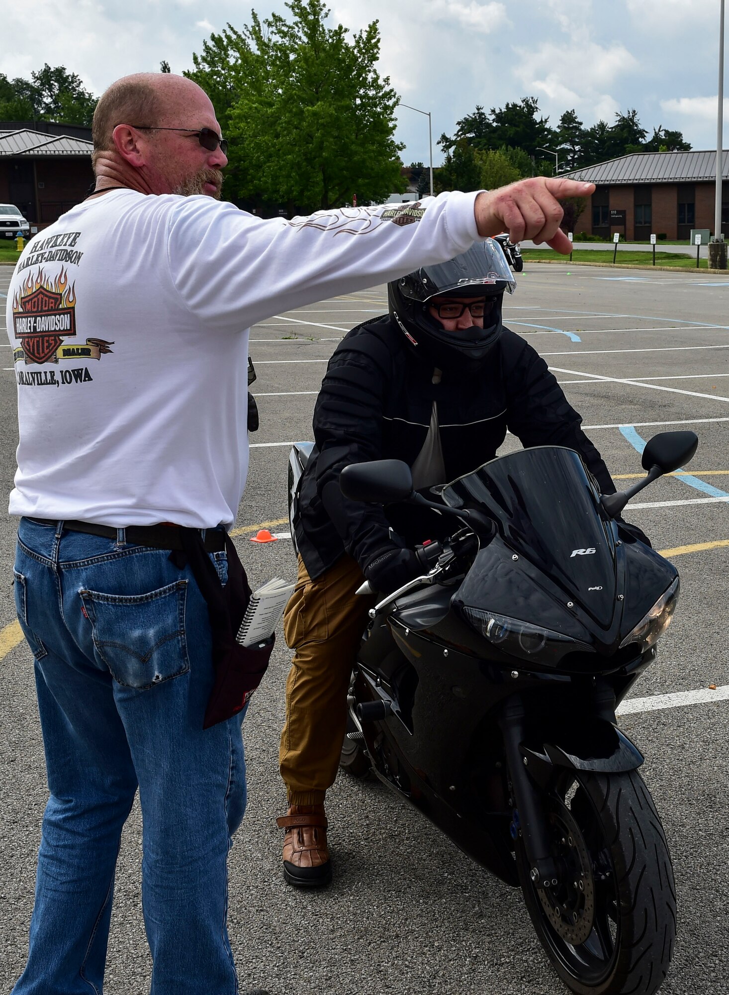 Retired Tech. Sgt. Andy Ford, now an occupational safety manager with the 910th Airlift Wing, instructs Senior Airman Brandon Simmons, an administration journeyman with the 910th Maintenance Group July 14, 2017, here. After every completed lap, instructors provided feedback on how each rider could improve. (U.S. Air Force Photo/Senior Airman Jeffrey Grossi)