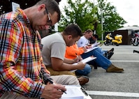 910th Airlift Wing Command Chief Master Sgt. Robert J. Potts reviews a motorcycle safety workbook when put on break from the motorcycle safety course July 14, 2017, here. The motorcycle safety course consists of group discussions, a skills test and ends with written exam. (U.S. Air Force Photo/Senior Airman Jeffrey Grossi)