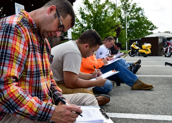 910th Airlift Wing Command Chief Master Sgt. Robert J. Potts reviews a motorcycle safety workbook when put on break from the motorcycle safety course July 14, 2017, here. The motorcycle safety course consists of group discussions, a skills test and ends with written exam. (U.S. Air Force Photo/Senior Airman Jeffrey Grossi)