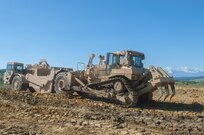 Spc. Jesse Jones, 323rd Engineer Company, 391st Engineer Battalion, 926th Engineer Brigade, uses a D7R II Dozer to push a scraper operated by Spc. Nathan Plank during Resolute Castle 17, in Cincu, Romania, July 14, 2017.  Resolute Castle 2017 is a U.S. Army Reserve led, United States Army Europe sponsored, Multi-Component, Multi-National Engineer Readiness Training Exercise.   Resolute Castle improves interoperability, enhances confidence and security assurance between partner nations, and improve infrastructure, capability and capacity at select locations.