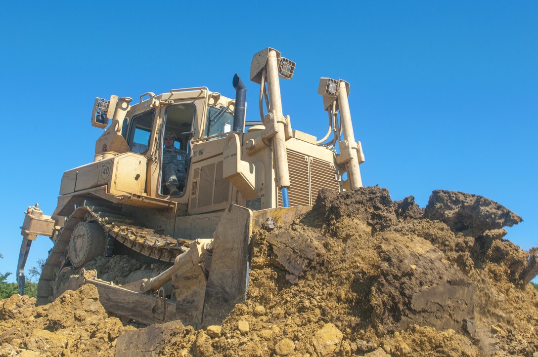 Spc. Jesse Jones, 323rd Engineer Company, 391st Engineer Battalion, 926th Engineer Brigade, uses a D7R II Dozer to remove a dirt bank during Resolute Castle 17, in Cincu, Romania, July 14, 2017.  Spc. Jones left behind his job as a heavy equipment operator at Foremost Pipline Construction, in South Carolina to serve on the site at Cincu says, “This mission in Romania gives Soldiers the ability to apply real world civilian skills to a military project.” Resolute Castle 2017 is a U.S. Army Reserve led, United States Army Europe sponsored, Multi-Component, Multi-National Engineer Readiness Training Exercise.   Resolute Castle improves interoperability, enhances confidence and security assurance between partner nations, and improve infrastructure, capability and capacity at select locations.