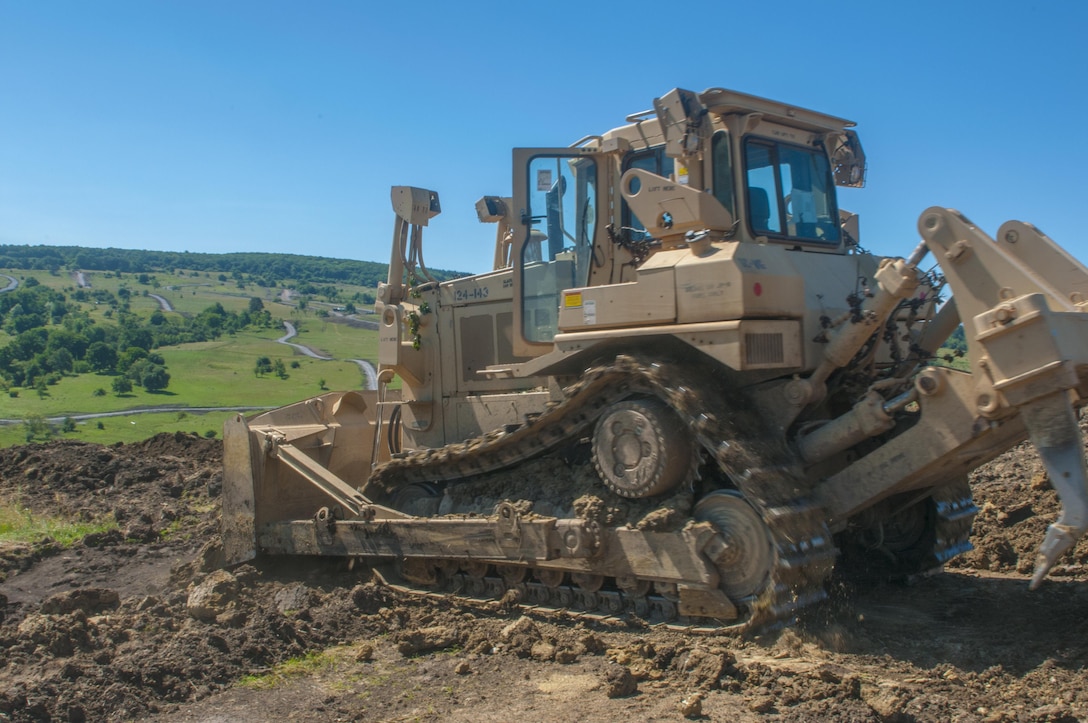 Spc. Jesse Jones, 323rd Engineer Company, 391st Engineer Battalion, 926th Engineer Brigade, uses a D7R II Dozer to remove a dirt bank during Resolute Castle 17, in Cincu, Romania, July 14, 2017.  Spc. Jones left behind his job as a heavy equipment operator at Foremost Pipline Construction, in South Carolina to serve on the site at Cincu says, “This mission in Romania gives Soldiers the ability to apply real world civilian skills to a military project.” Resolute Castle 2017 is a U.S. Army Reserve led, United States Army Europe sponsored, Multi-Component, Multi-National Engineer Readiness Training Exercise.   Resolute Castle improves interoperability, enhances confidence and security assurance between partner nations, and improve infrastructure, capability and capacity at select locations.