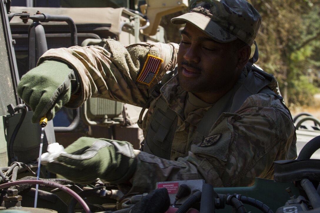 U.S. Army Reserve Spc. Keven Haley of 2nd Platoon, 130th Chemical Company checks the oil of tactical vehicle before departing on a training mission during the 91st Training Division's Combat Support Training Exercise (CSTX) on July 12, 2017 on Ft. Hunter Liggett, Calif. Haley trained on various tasks and drills during the CSTX.