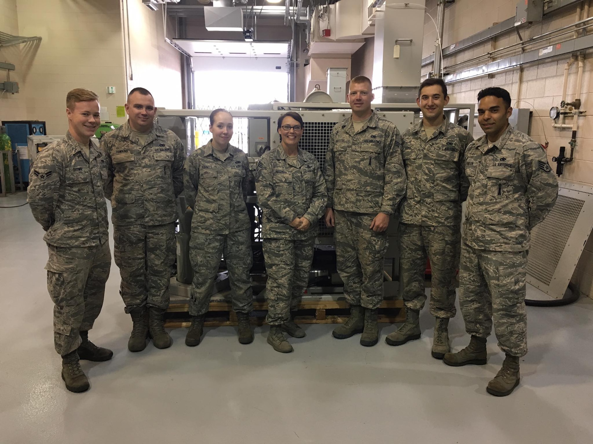 Chief Master Sgt. Amber Mitchell, 341st Missile Wing command chief, center, poses for a photo with Airmen from the 341st Maintenance Group at Malmstrom Air Force Base, Mont. Mitchell’s leadership style is all about transparency – ensuring every Airman is operating on the same playing field and that she is truly engaging with Airmen. (Courtesy photo)