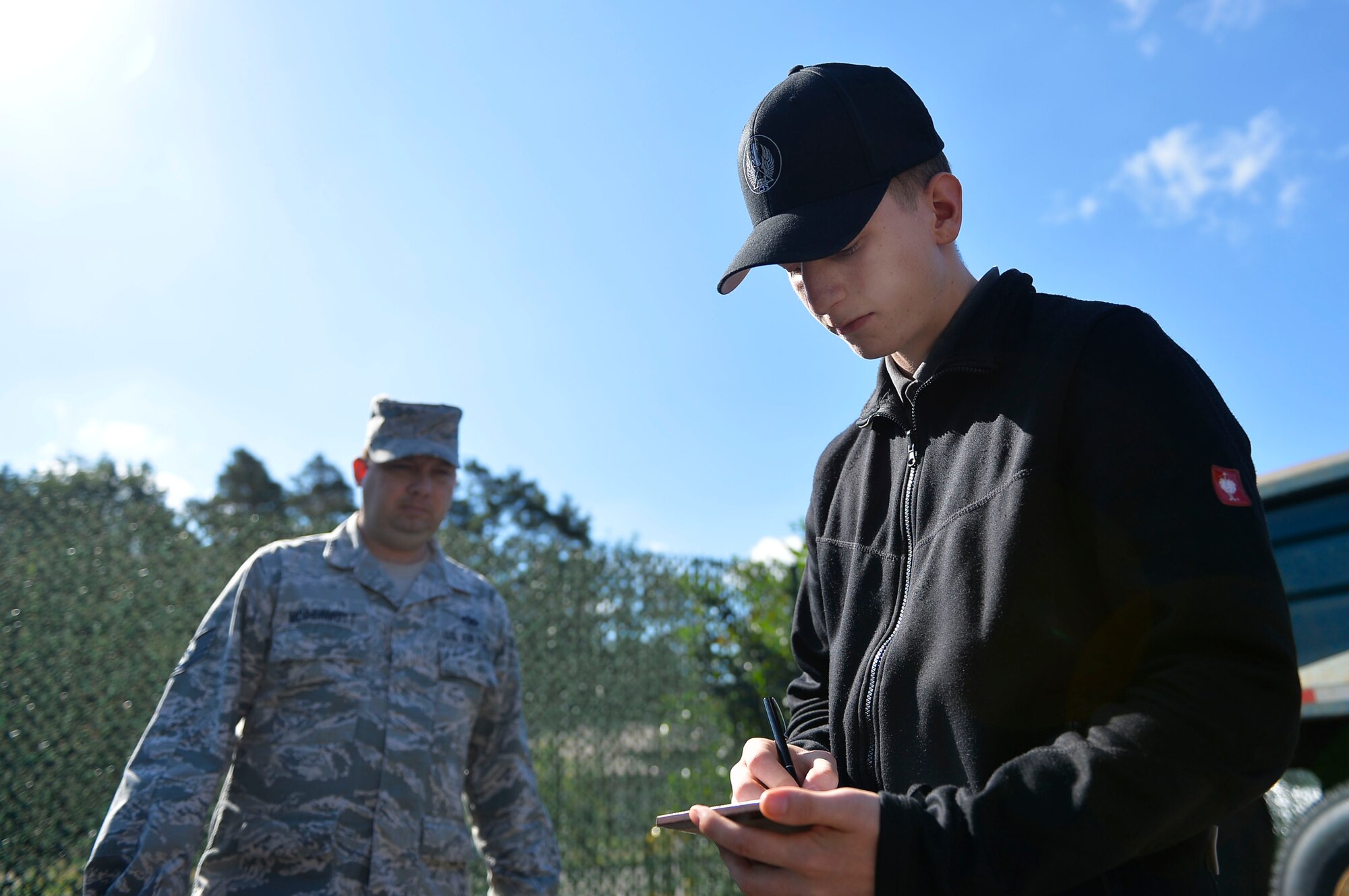 Felix Myer, 435th Construction and Training Squadron, administrative service clerk apprentice, writes down vehicle parts for purchase, on Ramstein Air Base, Germany, Jul. 13, 2017. The 435th CTS is conducting an apprenticeship training program for local national youth. (U.S. Air Force photo by Airman 1st Class Joshua Magbanua)