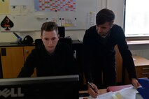 Andreas Lorenz, 435th Construction and Training Squadron supervisory purchasing agent (right), coaches his apprentice, Felix Myer, 435th CTS administrative service clerk, on computer operations on Ramstein Air Base, Germany Jul. 13, 2017. The 435th CTS’s three-year apprenticeship program provides vocational training opportunities for local national youth. (U.S. Air Force photo by Airman 1st Class Joshua Magbanua)