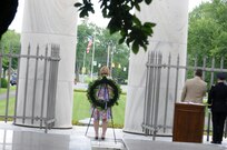 Sherry Hall, left, site manager for the Harding Home and Harding Memorial, along with Scott Schertzer, mayor of Marion, Ohio, and Brig. Gen. Stephen E. Strand, deputy commanding general for the U.S. Army Reserve's 88th Regional Support Command, honor the flag as it is lowered during the President Warren G. Harding wreath laying ceremony in Marion, Ohio, July 15.