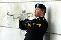 Sergeant Marty Maggart, from the 338th Army Band, plays Taps during the wreath laying ceremony honoring the 29th President of the United States, Warren G. Harding, in Marion, Ohio, July 15.