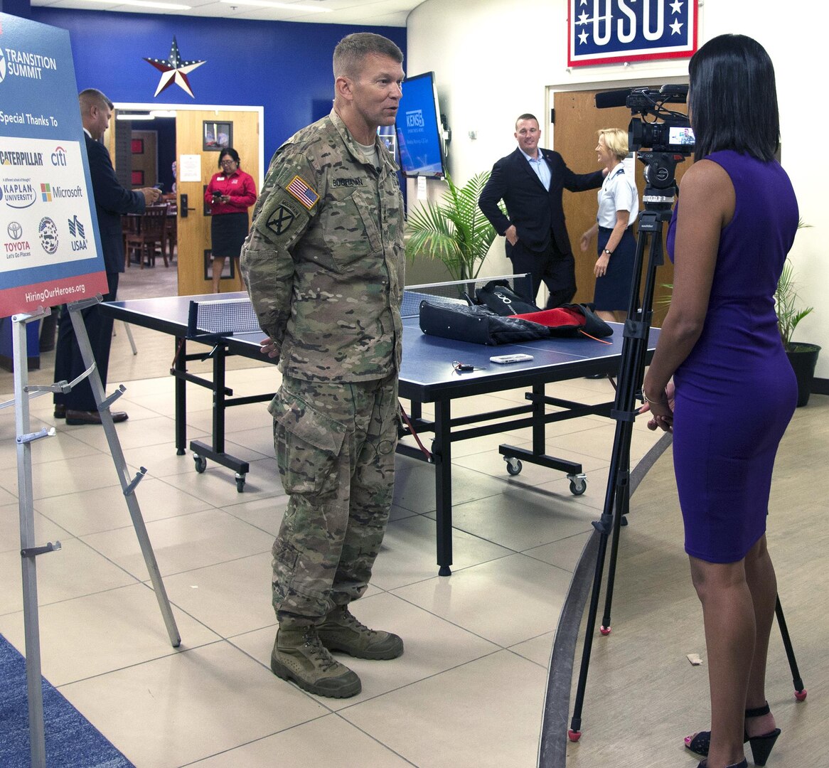 Lt. Gen. Jeffrey Buchanan (left), U.S. Army North (Fifth Army) commanding general, is interviewed by a reporter from a local television station during the transition summit and job fair at the Fort Sam Houston Community Center at Joint Base San Antonio-Fort Sam Houston July 13.