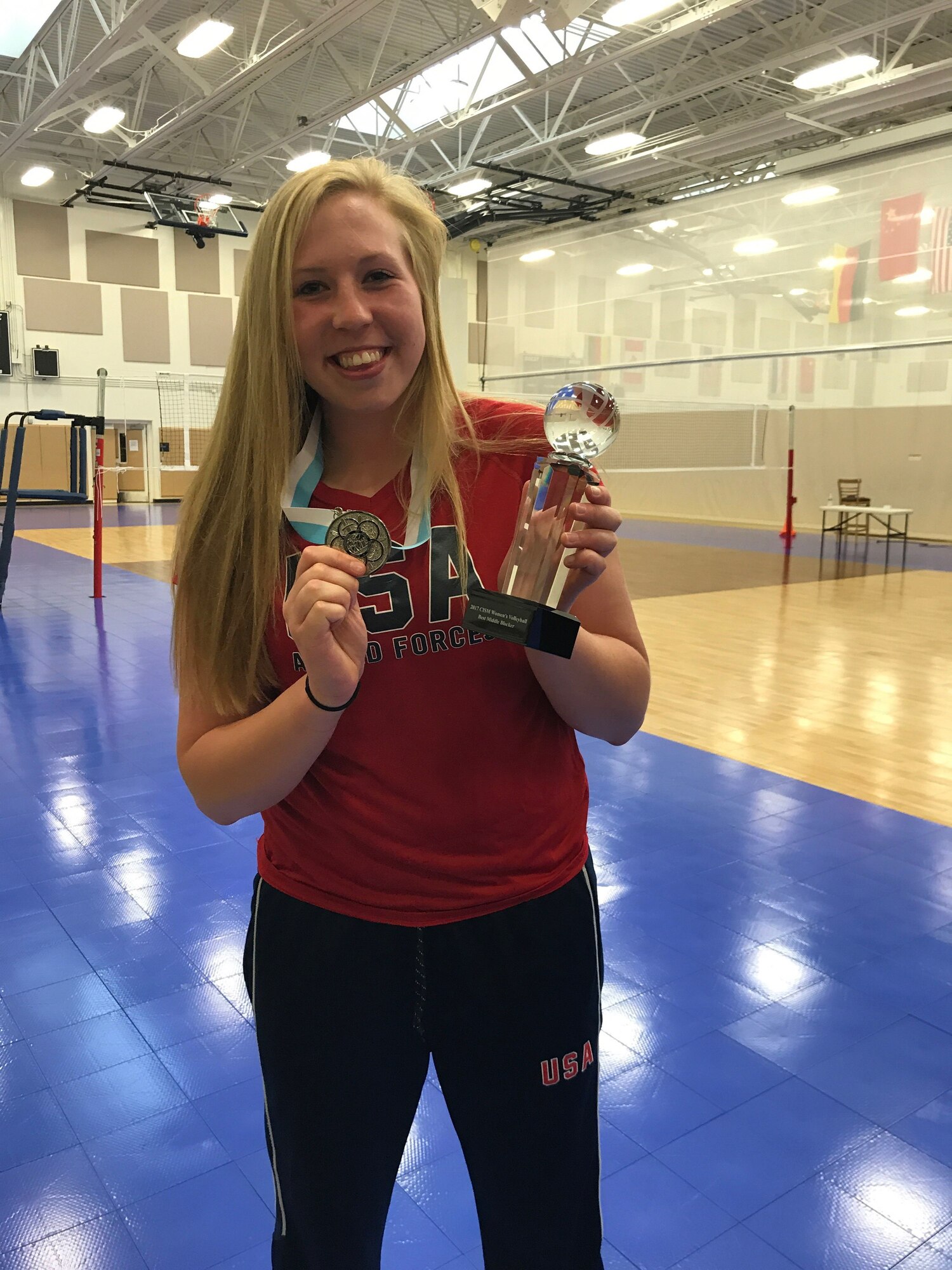 2nd Lt. Taylor Parker, 10th Missile Squadron missileer, shows off her awards for the best middle blocker and second place against China during the 18th Conseil International du Sport Militaire World Military Women’s Volleyball Championship. Parker was one of 12 women selected to represent the United States in a volleyball tournament against Germany, China, Canada and the Netherlands. (Courtesy photo)