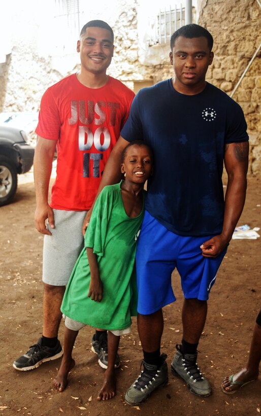 Army Sgt. R.J. Gibson and Army Spc. Casey Farr pose for a photo with a child from the Caritas refugee compound in Djibouti, July 6, 2017. The soldiers are assigned to Headquarters and Headquarters Company, 1st Battalion, 153rd Infantry Regiment, 39th Infantry Brigade Combat Team.
Army National Guard photo by Spc. Victoria Eckert
