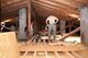 Members of the 219th RED HORSE Squadron verify joists are level on a catwalk in the attic of a barracks June, 14, 2017, Pocek base, near Postonja, Slovenia. The catwalk was built as a way to easily maneuver the attic for future maintenance. (U.S. Air National Guard photo/Staff Sgt. Lindsey Soulsby)