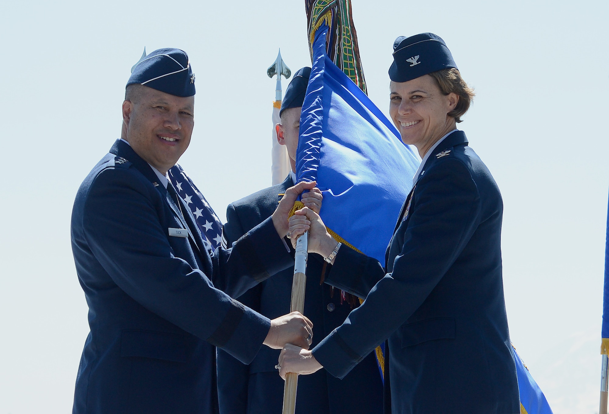 Col. Rebecca Sonkiss (right), 62nd Airlift Wing commander, accepts the 62nd AW guidon from Lt. Gen. Giovanni Tuck (left), 18th Air Force commander, during a change of command ceremony July 14, 2017, at Joint Base Lewis-McChord, Wash. Sonkiss is the former vice wing commander of the 455th Air Expeditionary Wing. Bagram Air Field, Afghanistan. (U.S. Air Force photo/Staff Sgt. Divine Cox)  