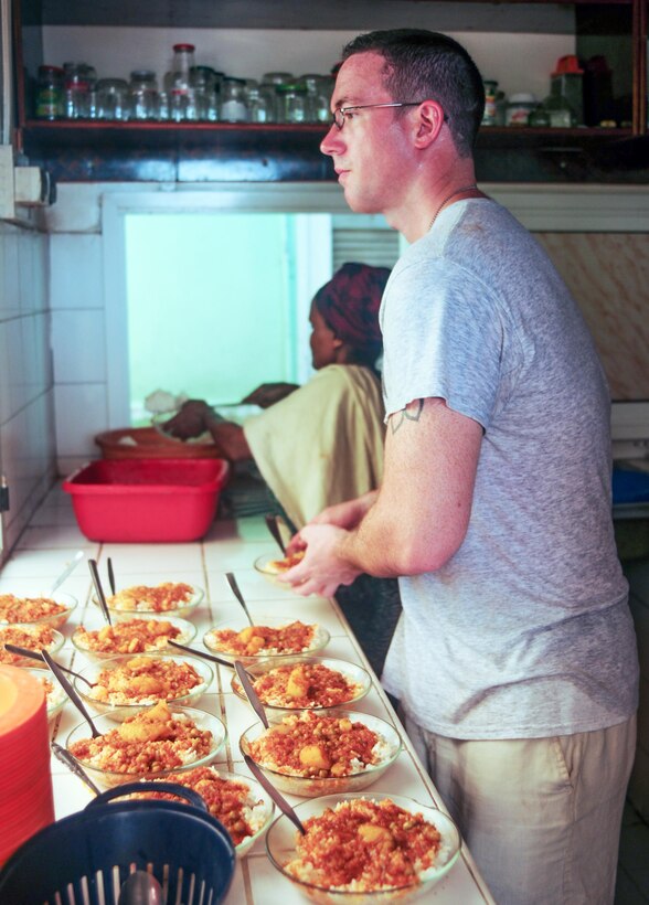 Army 1st Lt. Joshua Rusher helps prepare lunch at the Caritas refugee compound in Djibouti, July 6, 2017. Rusher is assigned to 1st Battalion, 153rd Infantry Regiment, 39th Infantry Brigade Combat Team.  Army National Guard photos by Spc. Victoria Eckert
