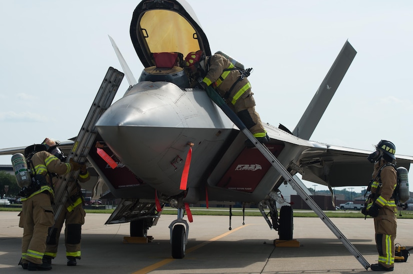 U.S. Air Force Airmen assigned to the 633rd Civil Engineer Squadron fire department extract a pilot from a simulated aircraft crash during an exercise at Joint Base Langley-Eustis, Va., July 11, 2017. The exercise provided several career fields the opportunity to train within their functional area, while learning proper response techniques and procedures for a real-world aircraft mishap or crash. (U.S. Air Force photo/Senior Airman Derek Seifert)