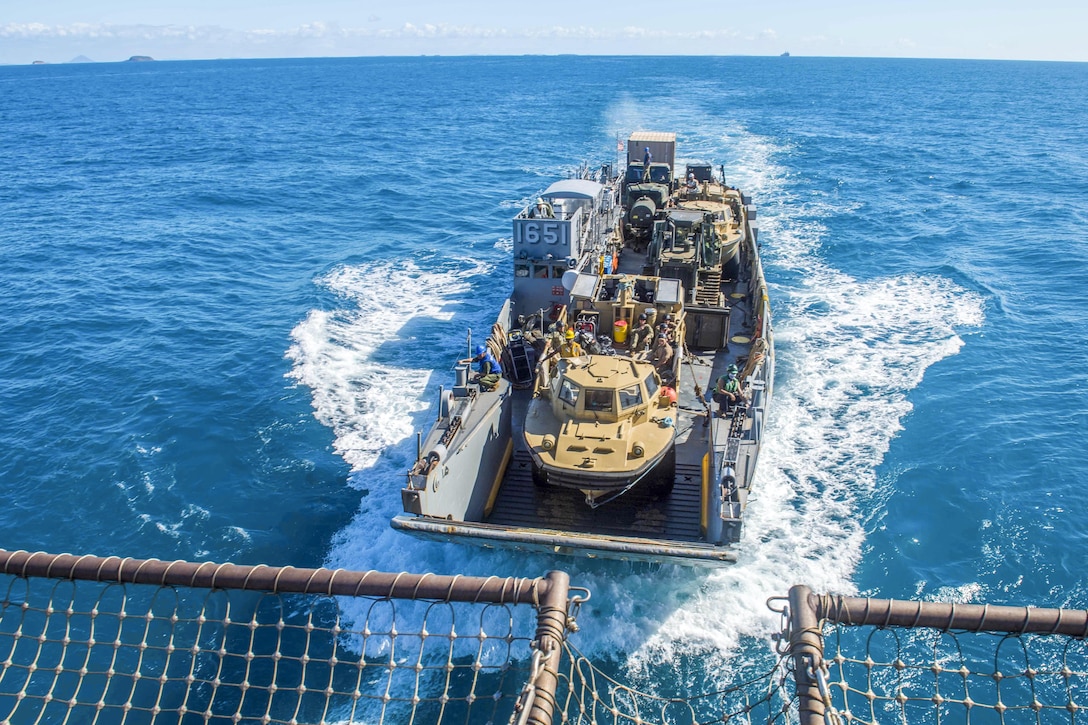 Marines and sailors aboard a landing craft return to the well deck of the USS Ashland in the Coral Sea, July 15, 2017, after participating in a large-scale amphibious assault event as part of exercise Talisman Saber 17. Talisman Saber is a biennial U.S.-Australia exercise. Navy photo by Petty Officer 3rd Class Jonathan Clay