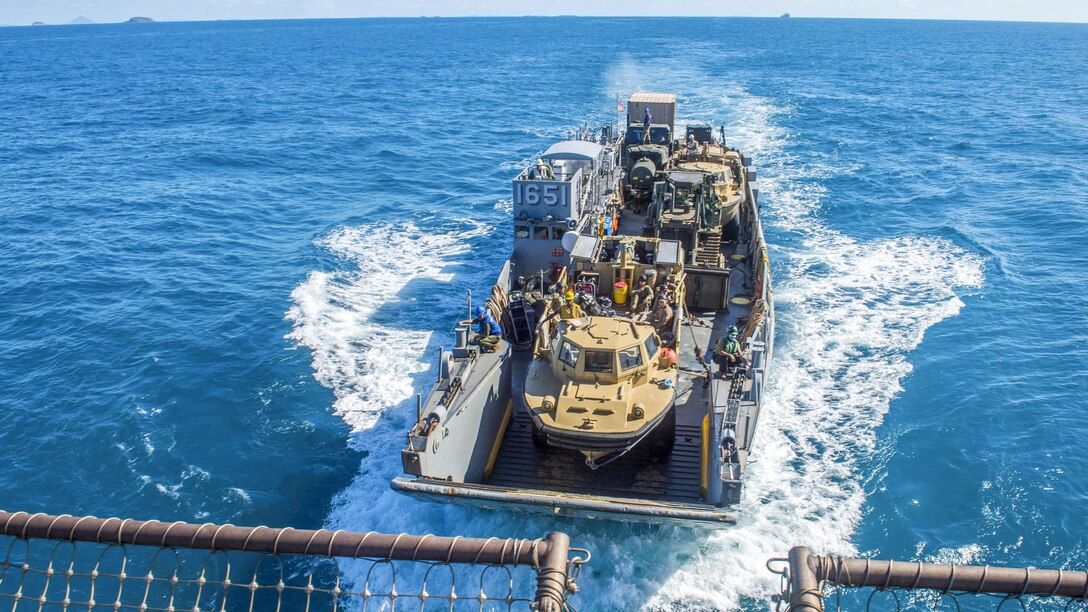 Marines and sailors aboard a landing craft return to the well deck of the USS Ashland in the Coral Sea, July 15, 2017, after participating in a large-scale amphibious assault event as part of exercise Talisman Saber 17. Talisman Saber is a biennial U.S.-Australia exercise. Navy photo by Petty Officer 3rd Class Jonathan Clay