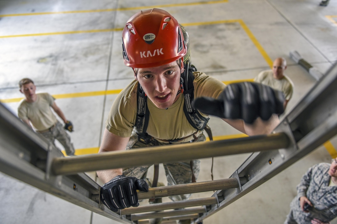 Air Force Academy Cadet 2nd Class Ryan Ramseyer climbs a ladder during a fire training challenge at Kunsan Air Base, South Korea, July 11, 2017. Cadets visited the base as part of an Air Force program educating them about jobs within the service. Air Force photo by Senior Airman Michael Hunsaker