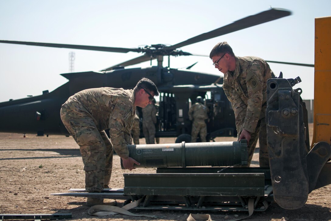 Paratroopers load munitions onto a UH-60 Black Hawk helicopter at Forward Operating Base Shalalot,  Iraq, July 6, 2017. The paratroopers are assigned to Charlie Battery, 2nd Battalion, 319th Airborne Field Artillery Regiment, 82nd Airborne Division. Army photo by Sgt. Christopher Bigelow

