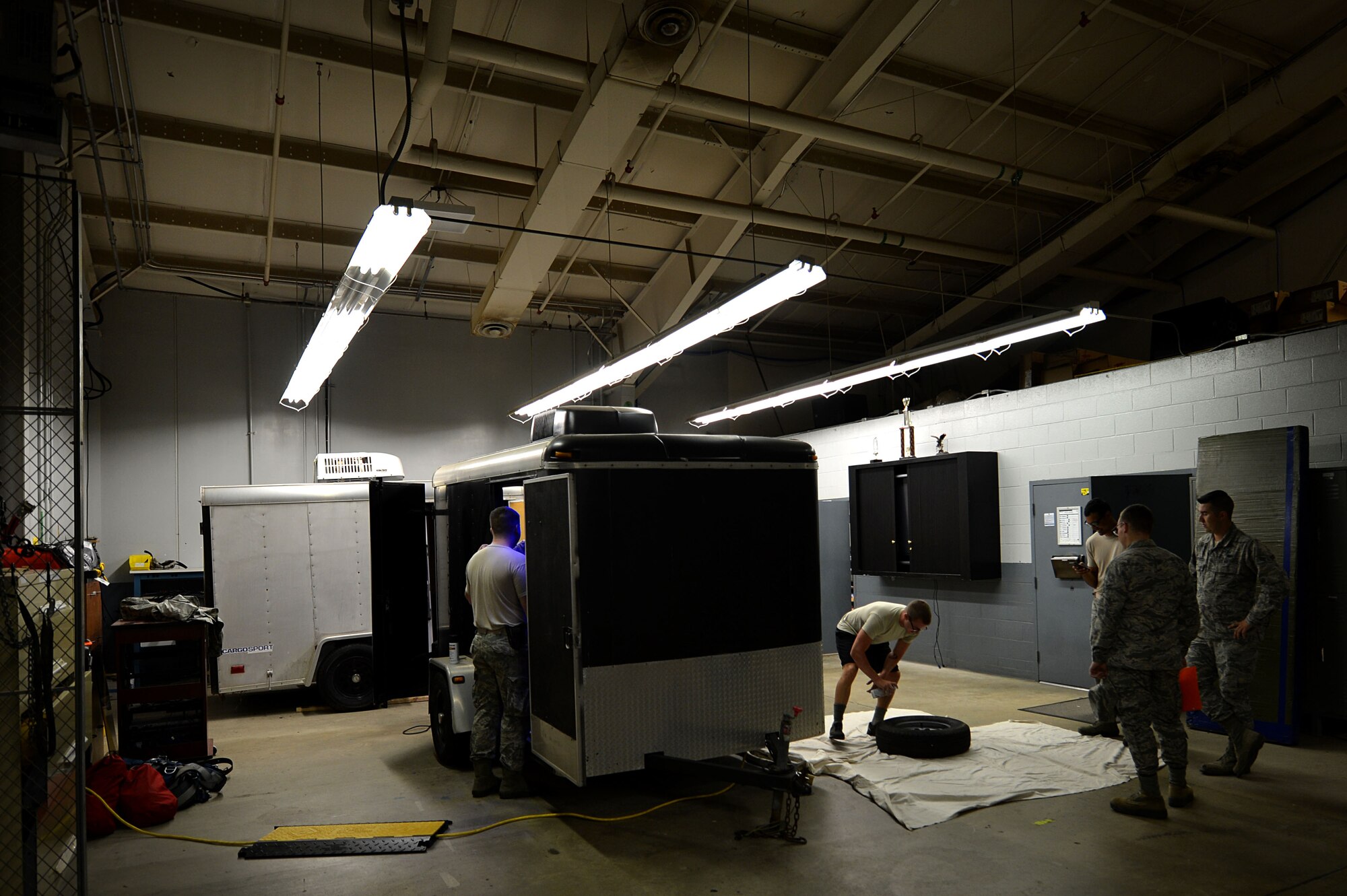 U.S. Airmen assigned to the 20th Communications Squadron (CS) radio frequency transmissions flight perform exterior renovations on the Gator 1 trailer, at Shaw Air Force Base, S.C., July 10, 2017. The 60 sq. foot trailers, Gator 1 and Gator 2, are capable of housing public announcement equipment as well as radio-based modules. (U.S. Air Force photo by Senior Airman Christopher Maldonado)