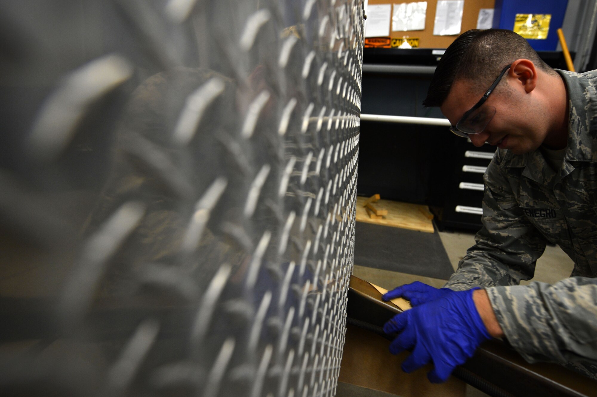 U.S. Air Force Airman 1st Class Thomas Montenegro, 20th Communications Squadron radio frequency transmissions journeyman, sands the hitch of emergency response trailer Gator 2, at Shaw Air Force Base, S.C., July 10, 2017. The trailer is scheduled to be completed by the end of this year. (U.S. Air Force photo by Senior Airman Christopher Maldonado)