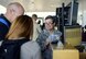 Tech. Sgt. Renee Kiger checks in and issues tickets to passengers at Ramstein Air Base's passenger terminal, July 13, 2017.  As a passenger terminal specialist and Air Transportation Journeyman with Joint Base Charleston's 81st Aerial Port Squadron, Kiger helped train at Ramstein with the active duty 721st APS.  Because Ramstein's Aerial Port is configured differently - and is much larger - than JB Charleston's, it serves as an opportunity for real-world training for the 81st APS's Citizen Airmen.  (U.S. Air Force photo by Senior Airman Jonathan Lane) 
