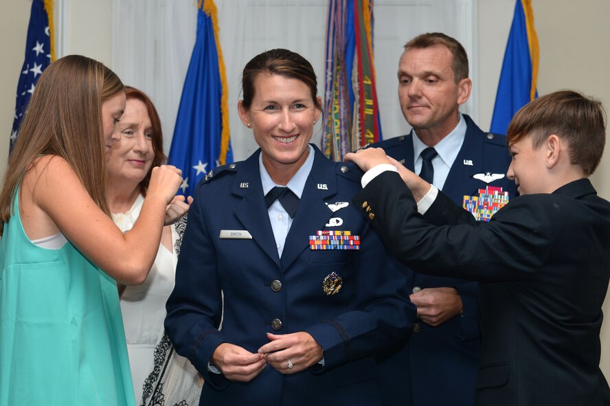 Col. Kristine B. Smith, the 710th Combat Operations Squadron deputy director, from Joint Base Langley-Eustis, Va., stands surrounded by her family as they pin on her colonel rank, July 14, 2017, Shaw Air Force Base, S.C. Smith was promoted by Col. Dustin P. Smith, the Headquarters U.S. Air Forces Central Command chief of staff, and her husband, as his last official duty in the Air Force. (U.S. Air Force photo/Senior Airman Christopher Maldonado)