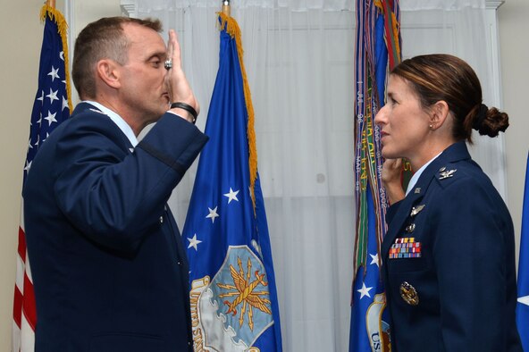 U.S. Air Force Col. Dustin P. Smith, Headquarters U.S. Air Forces Central Command chief of staff, promotes Col. Kristine B. Smith, 710th Combat Operations Squadron deputy director from Joint Base Langley-Eustis, Va., July 14, 2017, Shaw Air Force Base, S.C. The former USAFCENT chief of staff promoted his wife as his last official duty in the Air Force before retirement. (U.S. Air Force photo by Senior Airman Christopher Maldonado)