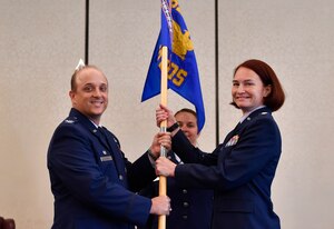 Col. Randall Lambert, left, 628th Medical Group commander, passes the guidon to Lt. Col. Christine Smetana, right, 628th Medical Operations Squadron incoming commander, during the 628th MDOS change of command ceremony at Joint Base Charleston, S.C., July 14, 2017. The squadron bid farewell to the outgoing commander Lt. Col. Brian Neese and welcomed Smetana as the new squadron commander. 