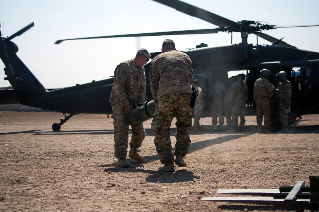 Paratroopers load munitions onto a UH-60 Black Hawk helicopter at Forward Operating Base Shalalot, Iraq, July 6, 2017. Army photo by Sgt. Christopher Bigelow