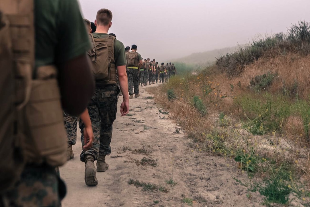 Marines of Company A, 9th Communication Battalion conduct a Company physical training evolution on 21 June 2017 hiking through several miles of rolling hills of Camp Pendleton.