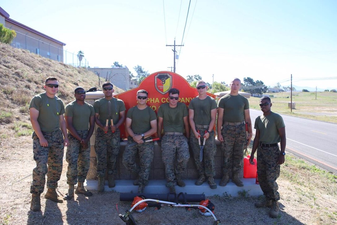 Marines of Company A, 9th Communication Battalion take a break during a Battalion-wide beautification effort on 30 June 2017.