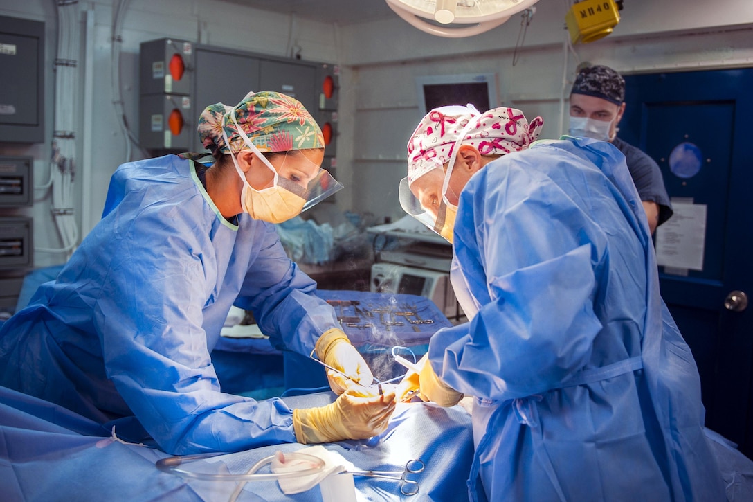 Navy Hospital Corpsman 1st Class Christina Sizemore, left, and Lt. Cmdr. Krista Puttler, a ship’s surgeon, perform surgery aboard the aircraft carrier USS George H.W. Bush in the Mediterranean Sea, July 11, 2017. The ship and its carrier strike group are conducting naval operations in the U.S. 6th Fleet area of operations to support U.S. national security interests in Europe and Africa. Navy photo by Petty Officer 3rd Class Joe Boggio