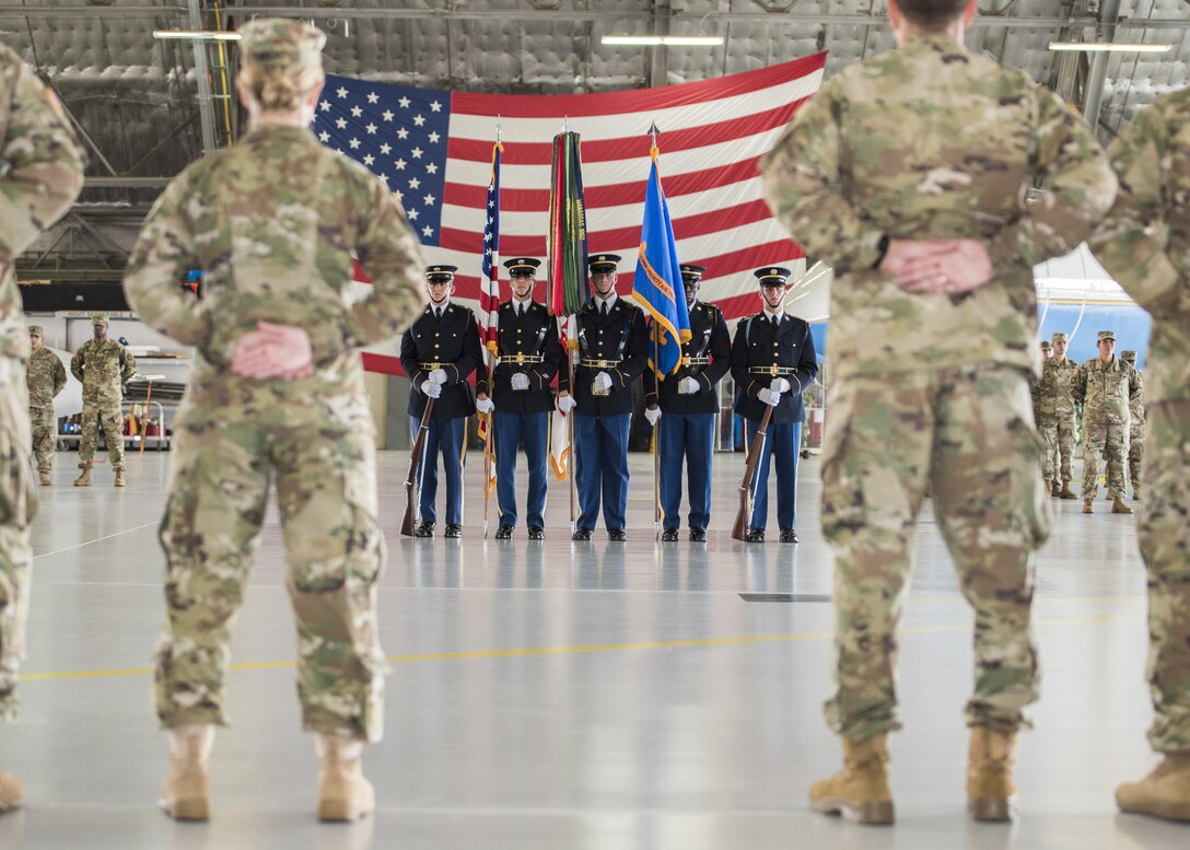 U.S. Army color guard members stand in Hangar Two during the U.S. Army Priority Air Transport Command change of command and responsibility ceremony at Joint Base Andrews, Md., July 14, 2017. The colors are a symbol of the commander’s authority and are a reminder of the responsibility they have to execute the unit’s mission and care for its personnel and equipment. The role of commander was passed from Lt. Col. Heather L. Maki to Lt. Col. Matthew L. Rowland during the event. (U.S. Air Force photo by Senior Airman Jordyn Fetter)