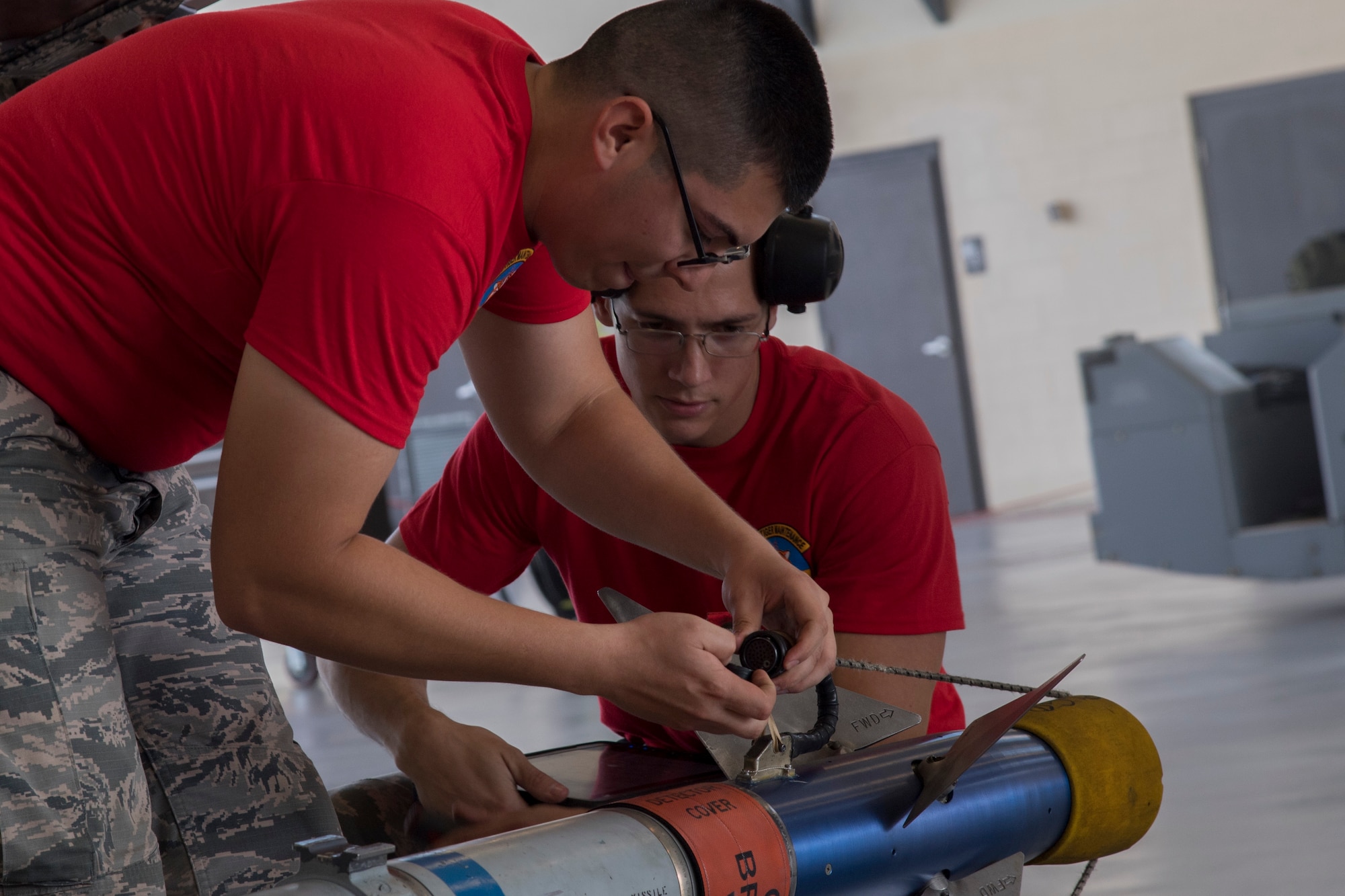 Airman 1st Class Alan Oseguera (left), 75th Aircraft Maintenance Unit weapons load crew member, and Staff Sgt. Christopher Carlson, 75th AMU weapons load team chief, prepare to load a AIM-9 Sidewinder, during the weapons load competition July 14, 2017, at Moody Air Force Base, Ga. Every quarter members of the 74th and 75th AMU competes in the quarterly competition that tests knowledge, dress and appearance, and speed of loading a GBU-12 joint direct attack munition and AIM-9 Sidewinder. (U.S. Air Force photo by Staff Sgt. Eric Summers Jr.)
