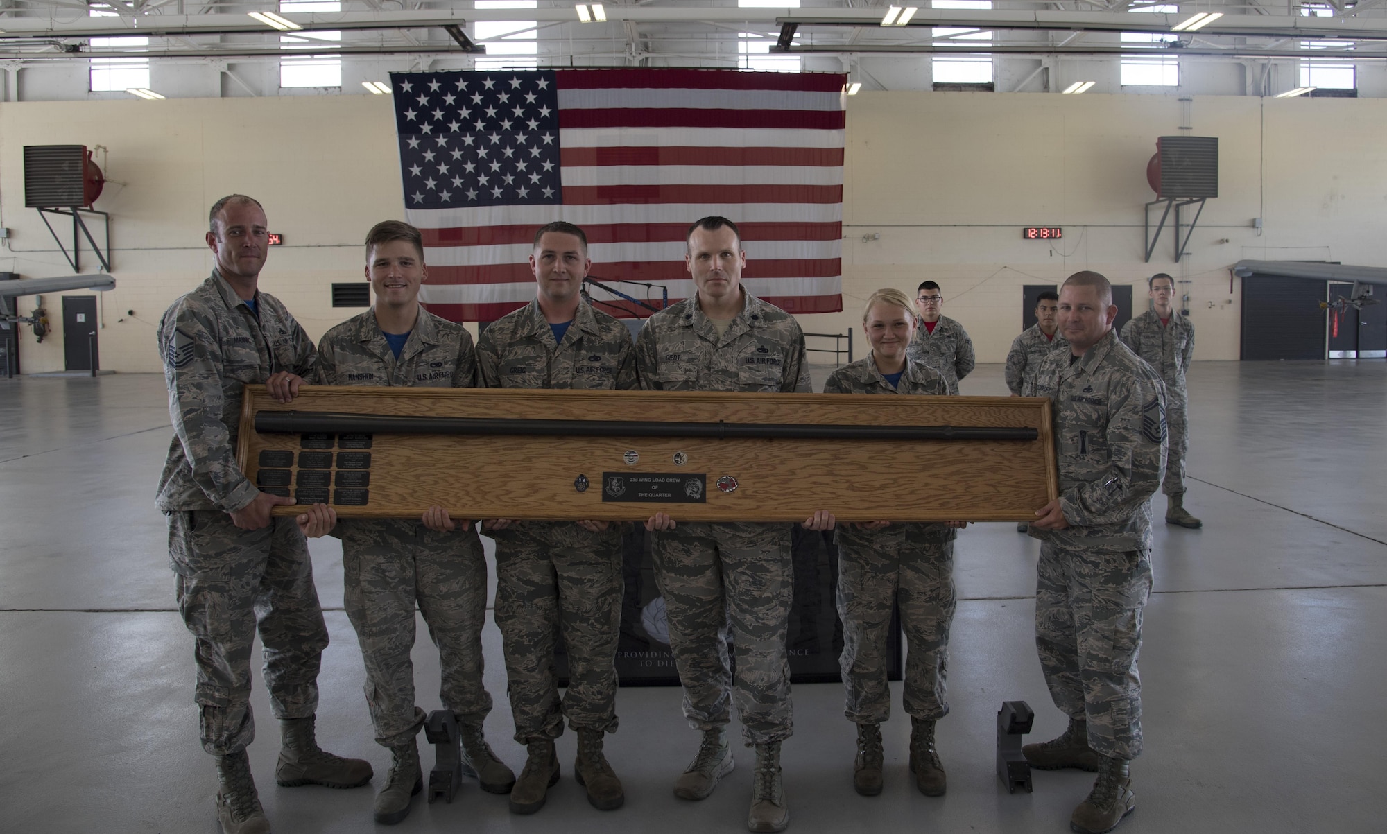 Members of the 74th Aircraft Maintenance Unit hold up the Load Crew of the Quarter award after beating the 75th AMU, July 14, 2017, at Moody Air Force Base, Ga. Every quarter members of the 74th and 75th AMU competes in the quarterly competition that tests knowledge, dress and appearance, and speed of loading a GBU-12 joint direct attack munition and AIM-9 Sidewinder. (U.S. Air Force photo by Staff Sgt. Eric Summers Jr.)