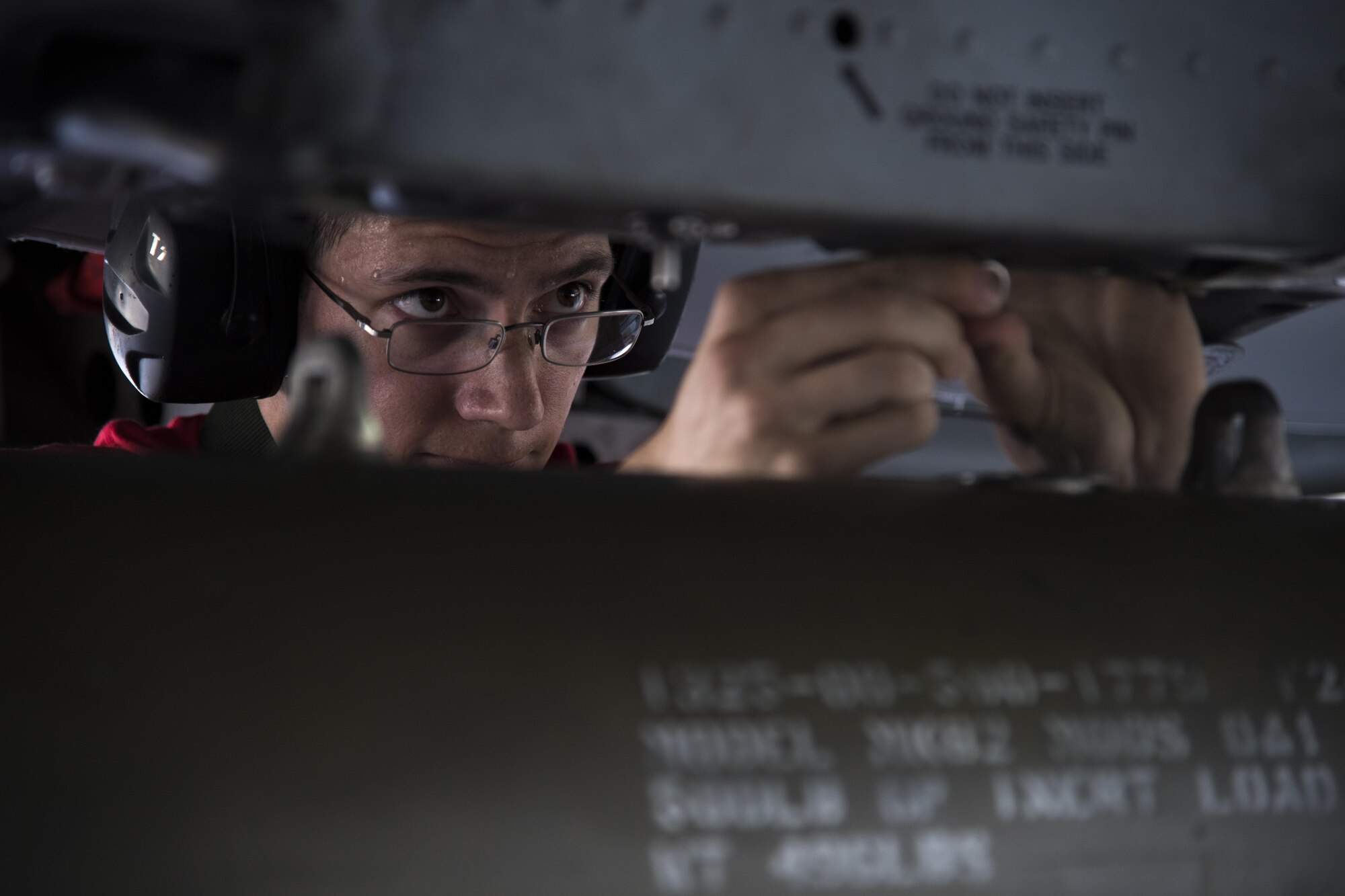 Staff Sgt. Christopher Carlson, 75th Aircraft Maintenance Unit weapons load team chief, loads a GBU-12 joint direct attack munition during weapons load crew competition, July 14, 2017, at Moody Air Force Base, Ga. Every quarter members of the 74th and 75th AMU competes in the quarterly competition that tests knowledge, dress and appearance, and speed of loading a GBU-12 joint direct attack munition and AIM-9 Sidewinder. (U.S. Air Force photo by Staff Sgt. Eric Summers Jr.)