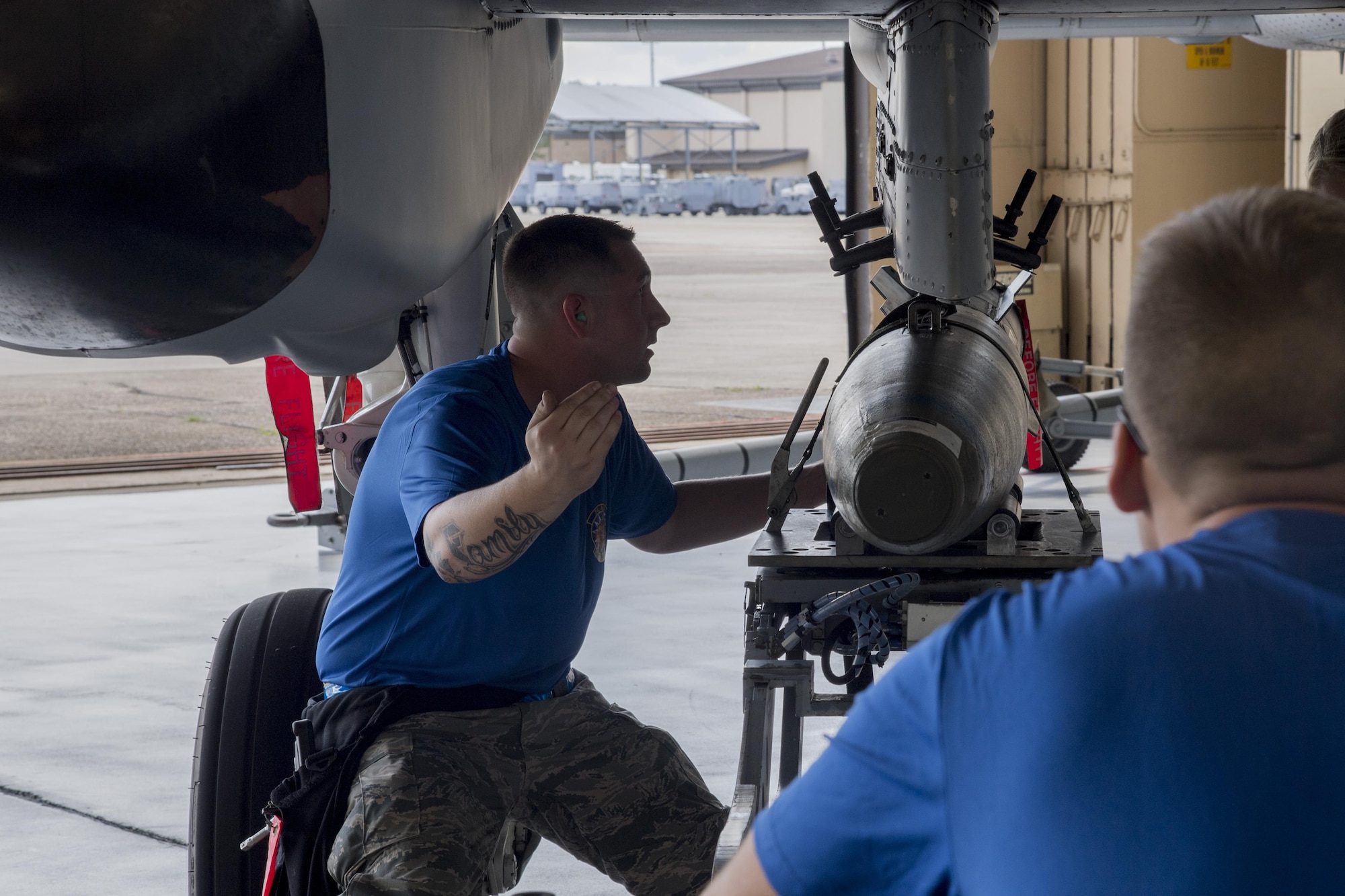 Staff Sgt. Johnathan Grieg, 74th Aircraft Maintenance Unit weapons load team chief, guides a GBU-12 joint direct attack munition to load onto an A-10C Thunderbolt II during a weapons load competition July 14, 2017, at Moody Air Force Base, Ga. Every quarter members of the 74th and 75th AMU competes in the quarterly competition that tests knowledge, dress and appearance, and speed of loading a GBU-12 joint direct attack munition and AIM-9 Sidewinder. (U.S. Air Force photo by Staff Sgt. Eric Summers Jr.)