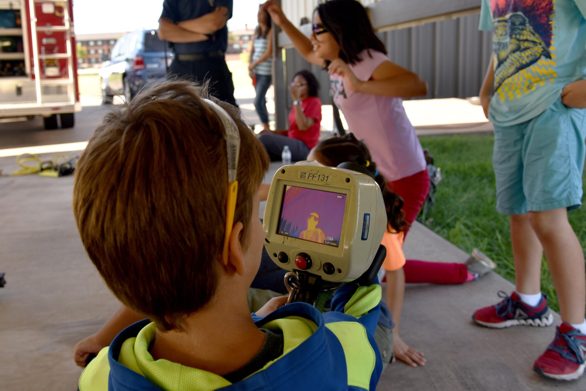 Jackson Syring, junior firefighter, uses a thermal imager during the junior firefighter camp at the fire station on Goodfellow Air Force Base, Texas, July 11, 2017. The firefighters taught the children that the thermal imager can be used to locate individuals in a smoky environment. (U.S. Air Force photo by Staff Sgt. Joshua Edwards/Released)