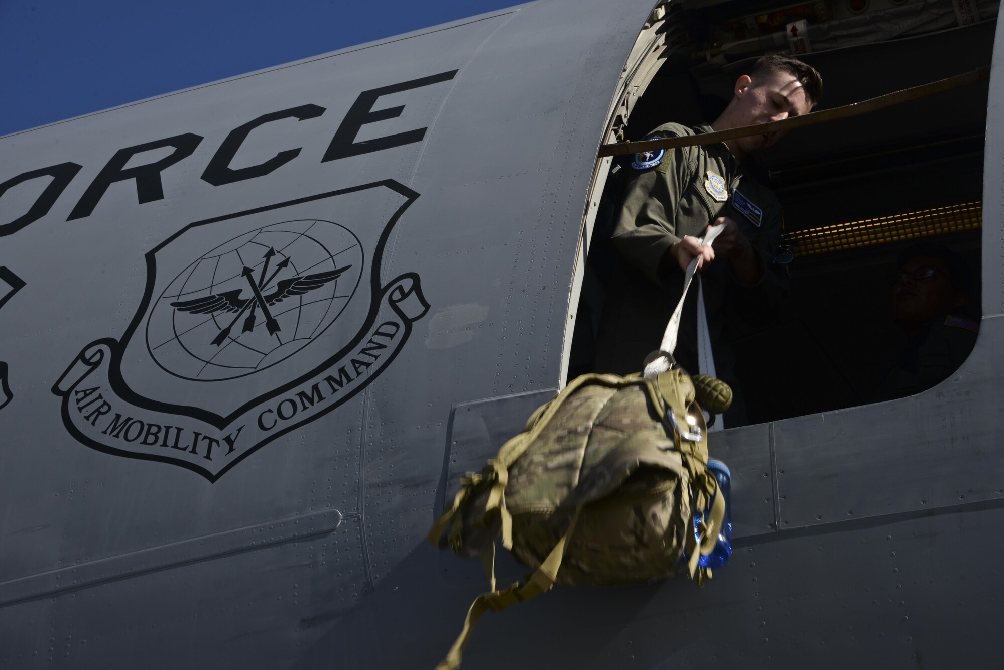 Airman 1st Class Patrick Tracy, 6th Air Refueling Squadron boom operator, loads aircrew equipment onto a KC-10 Extender at Royal Australian Air Force Base Richmond in Brisbane, Australia July 14, 2017. KC-10s from Travis AFB and Joint Base McGuire-Dix-Lakehurst, New Jersey, supported Exercise Talisman Saber 2017 by executing Exercise Ultimate Reach, a strategic refueling and airdrop mission in which three KC-10s refueled five C-17 Globemaster IIIs carrying U.S. Army, Australian and Canadian paratroopers prior to an airdrop. TS17 is a biennial exercise in Australia that focuses on bilateral military training between U.S. Pacific Command forces and the Australian Defence Force to improve U.S.-Australia combat readiness, increase interoperability, maximize combined training opportunities and conduct maritime prepositioning and logistics operations in the Pacific. (U.S. Air Force photo by 2nd Lt. Sarah Johnson)